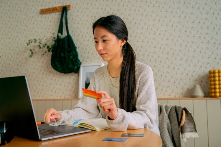 Person using a credit card to purchase products online