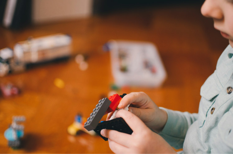 Child is playing with lego