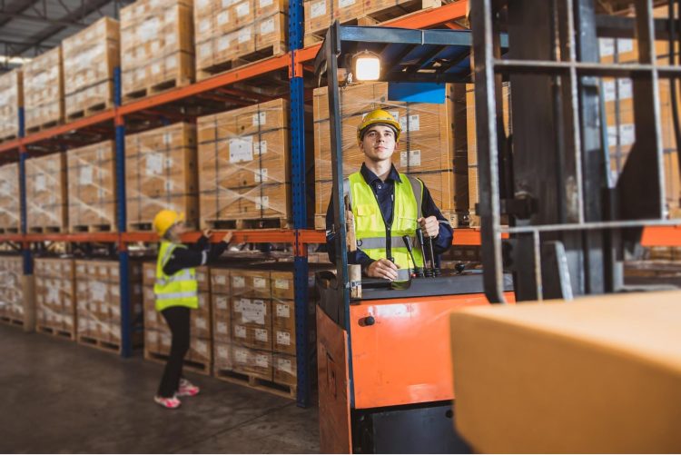 Worker drives a forklift