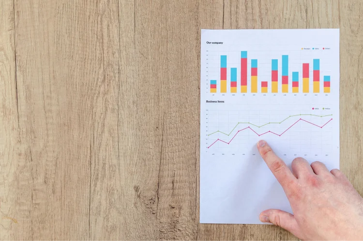 Person pointing paper line graph
