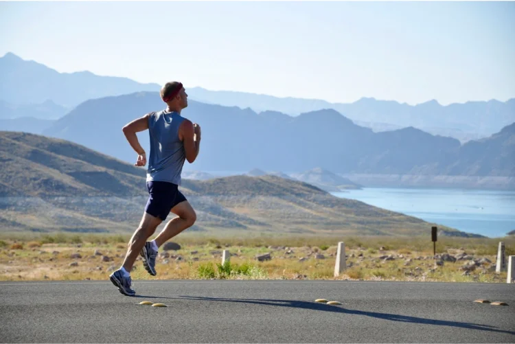 Man running past mountain scenery
