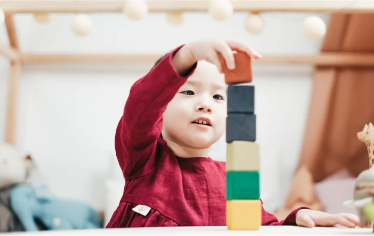 Small child using building blocks