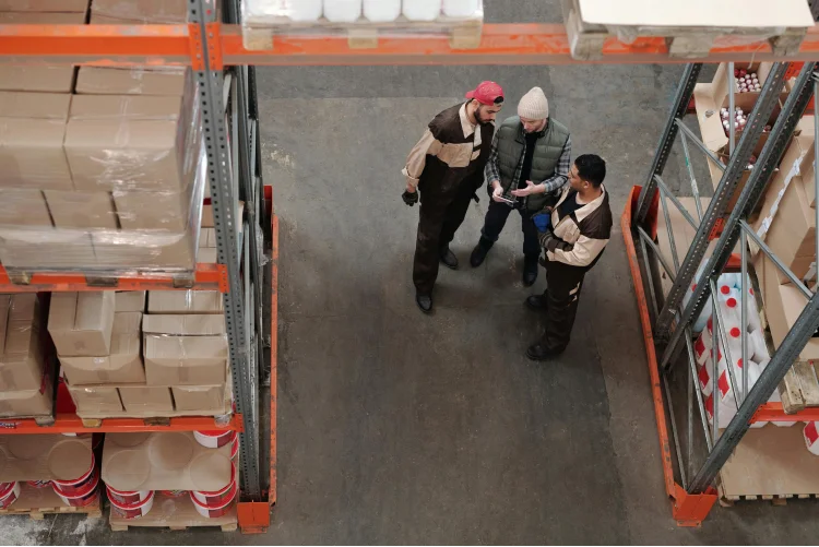 Men standing in a warehouse talking
