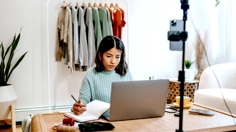 Woman clothes designer takes notes