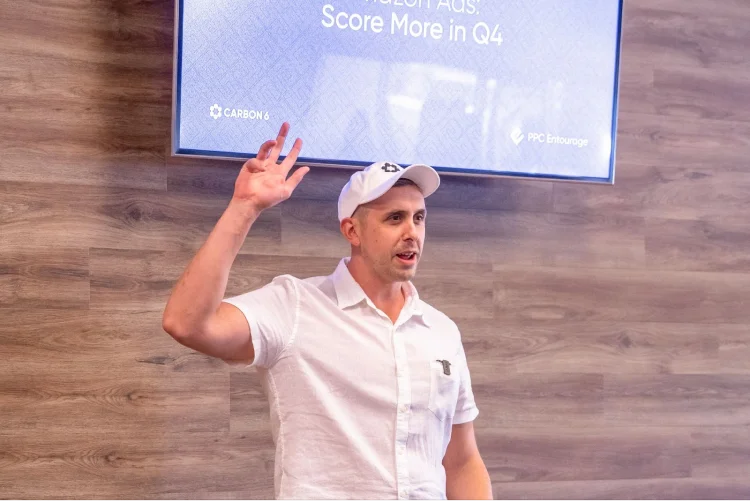 Person with hat on raising hand.