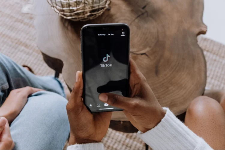 person holds phone opened to TikTok