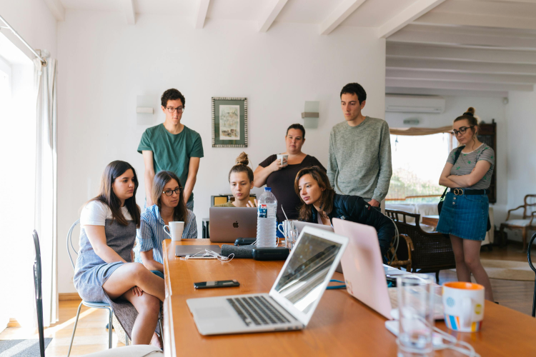 Group of people looking on macbook